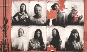 aging photos of women of different races plastered on a wall