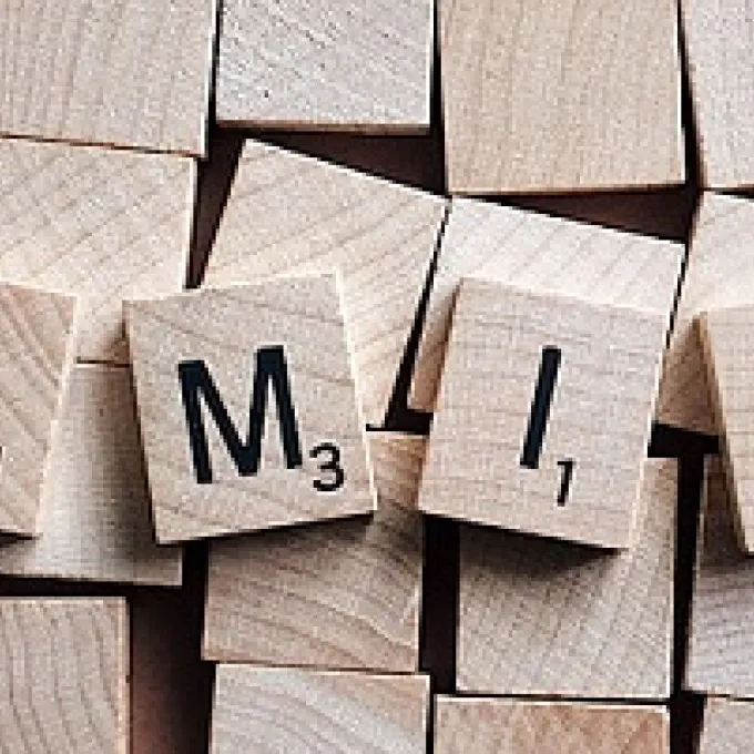 man, woman, child, and infant icons painted in yellow on blacktop surface