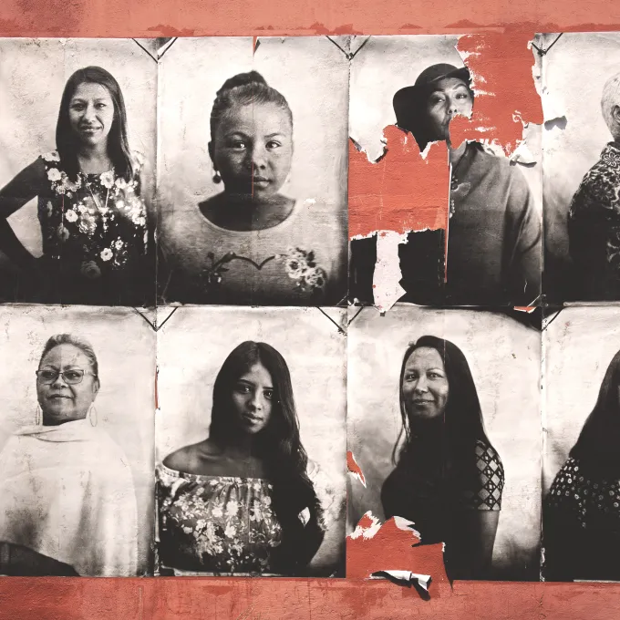 aging photos of women of different races plastered on a wall